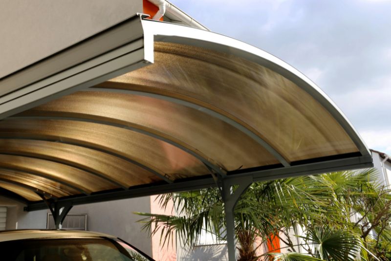 single, curved roof carport with a car parked