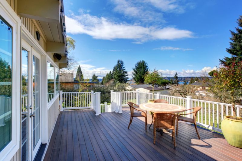 spacious back deck with dining table and chairs